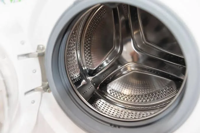 Close-up of a washing machine drum during inspection